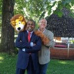 From right: DOC the Clown, aka David Polley, WCCM Vice President of Africa and Asia Jaideep Jesudoss, and Larry the Lion puppet that was stayed with the ministers of Kenya when the WCCM team left.